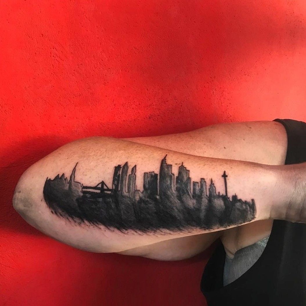 Fine line NYC skyline tattoo on the inner forearm