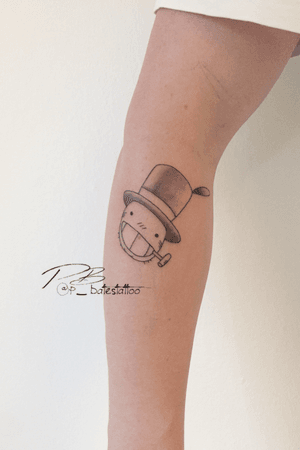 Get a sophisticated look with this fine line illustrative tattoo of a hat and smoking pipe on your forearm, by Patrick Bates.