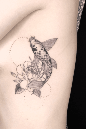 Stippled koi fish with fineline peony on the ribs