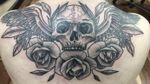 Skull wings and roses across the shoulders.