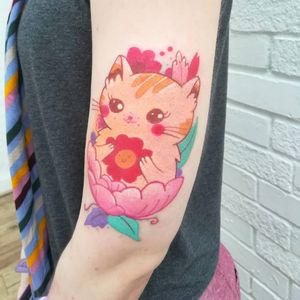 Adorable illustrative tattoo featuring a colorful kawaii cat design by the talented artist Adi D.