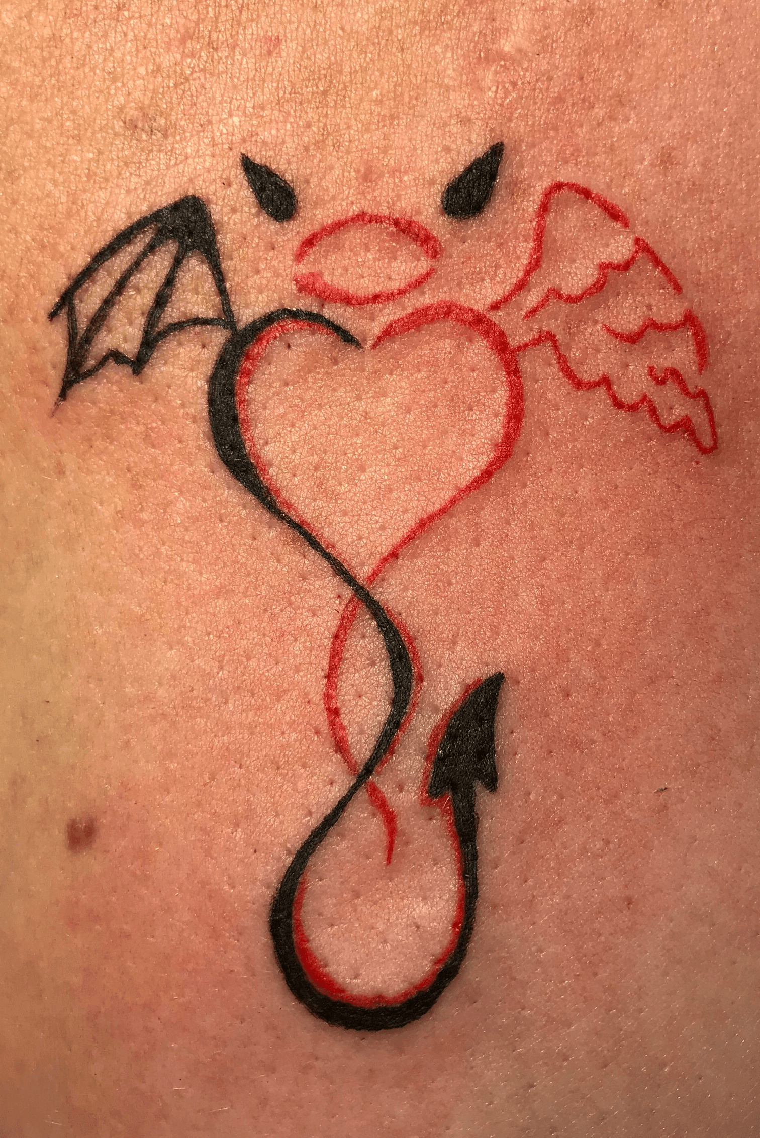 angel with devil horns tattoo