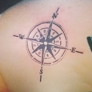 Rugged compass tattoo on the back