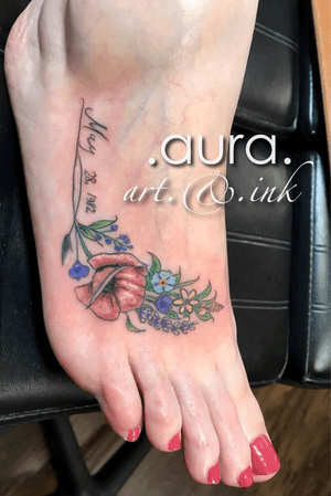 Fine-line floral foot tattoo.