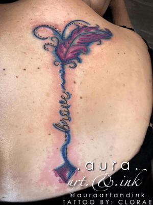 Watercolor arrow spine tattoo.