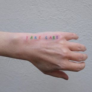Minimal tattoo by Victor Zabuga #VictorZabuga #minimaltattoos #minimal #smalltattoos #small #simpletattoo #simpletattoos #hand #takecare #words #letter #handpoke #color