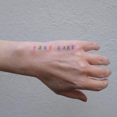 Minimal tattoo by Victor Zabuga #VictorZabuga #minimaltattoos #minimal #smalltattoos #small #simpletattoo #simpletattoos #hand #takecare #words #lettering #handpoke #color