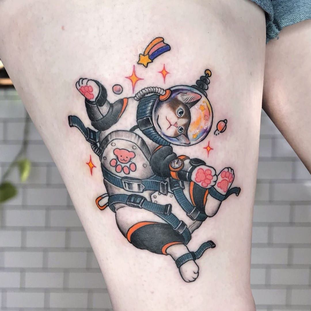 Astronaut tattoo on the back of the left arm