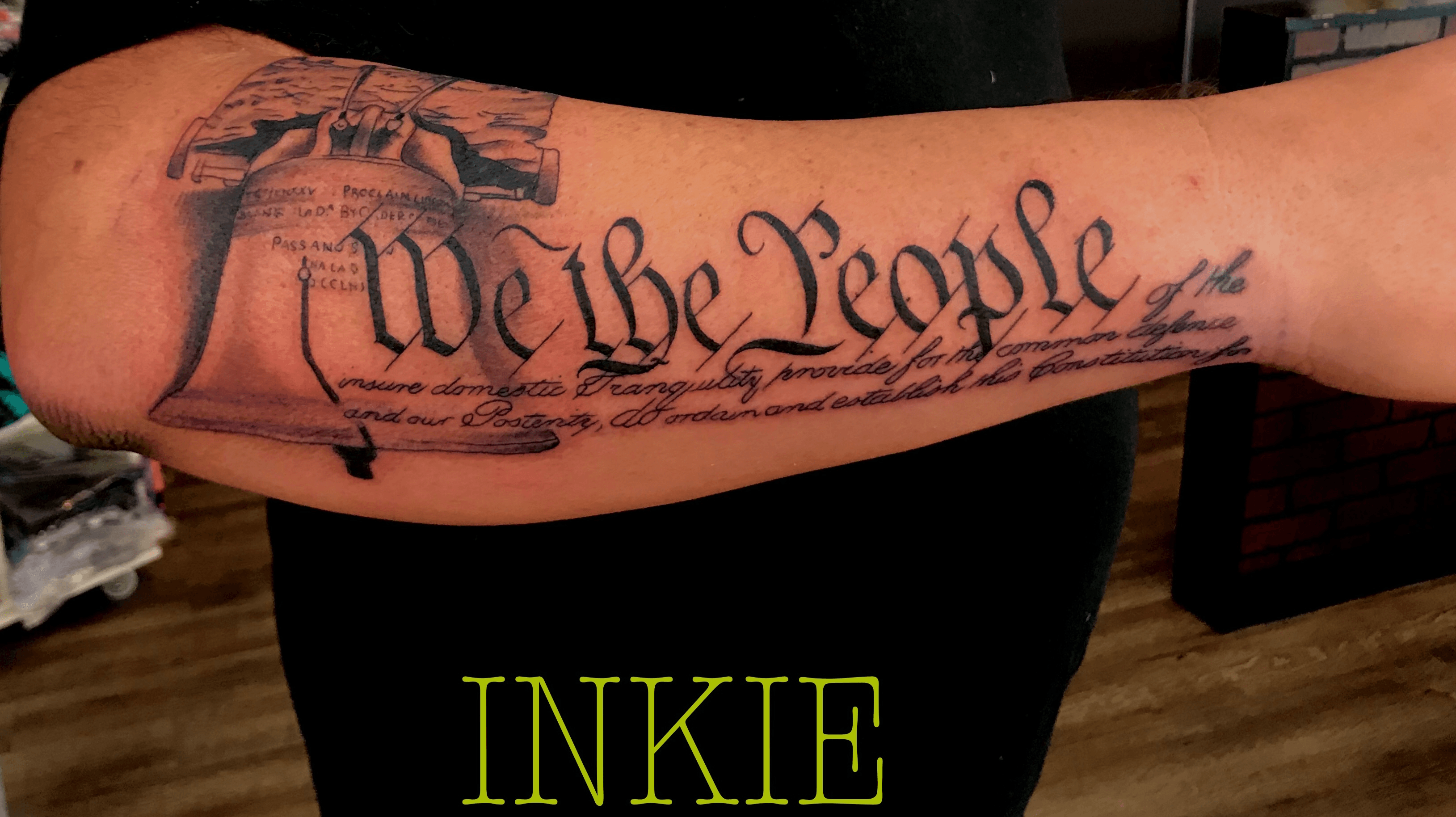 The tattoo We The People from the United States Constitution decorates  the arm of Trump supporter Bob Lewis left as he argues with counter  protester Ralph Gaines as Trump supporters demonstrate against