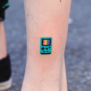 Cute tattoo of Zzizzi #Zzizzi #cutetattoos #cute #sweet #tattooforgirls #tattooforwomen #tattooideas #cooletattoos #love #handpoke #leg #color #gameboy #rainbow #tiny #videogame