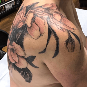 This was a large magnolia cover up done over multiple sessions covering a large portion of the back and draping over the shoulder.
