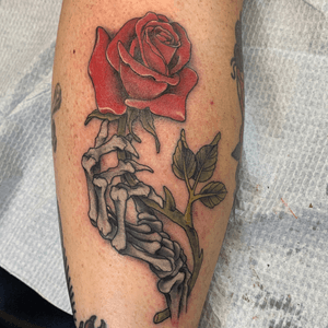 Skeletal hand and rose