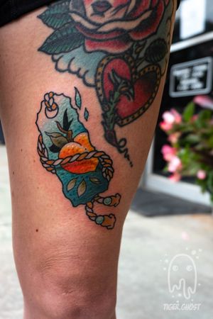 Peach themed Japanese omamori on the thigh