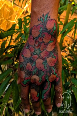 Chrysanthemum in color on dark skin. This was partly used to cover up names on his inner fingers. 