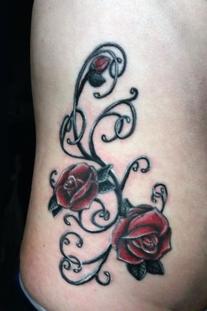 Ornamental Rose with wispy filigree done on the torso/ribs