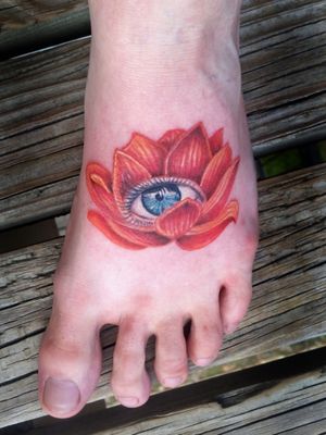 Lotus flower with eyeball done on the top of the foot 