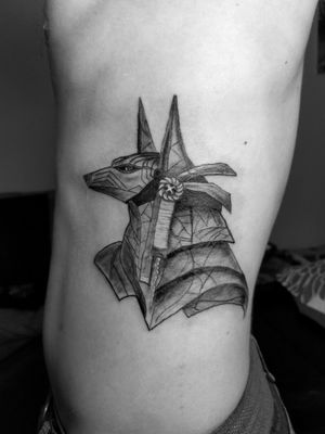 Black and grey work of the Egyptian deity "Anubis" tattoo done on the ribcage.