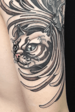 Cat on tricep with lion on the shoulder area with filigree in between.