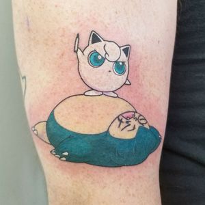 An angry Jigglypuff doodling on a snoozing Snorlax Please DM me through instagram or facebook for bookings @classylasslilith #pokemontattoo #pokemon #jigglypuff #snorlaxtattoo #customtattoo #colortattoo #animetattoo #videogametattoos 