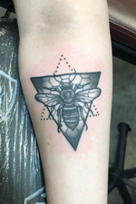 Black and grey bee with some honeycomb patterns