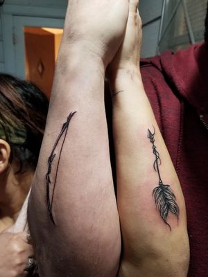 Couple's tattoo of bow and arrow 