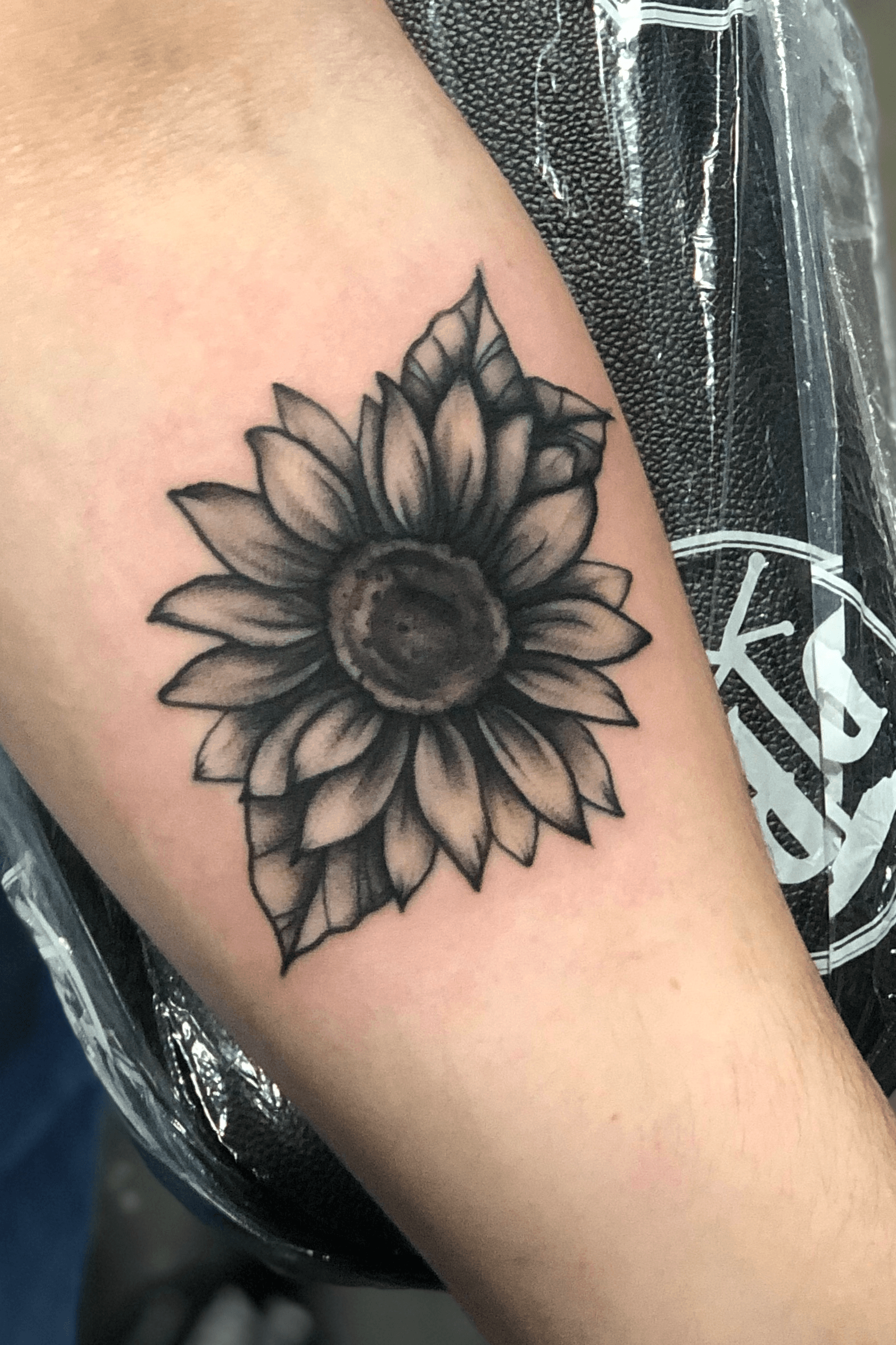 black and grey sunflower flower tattoo by DLacie TattooNOW