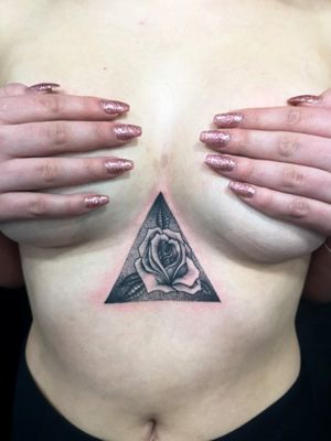 Black rose in a dotwork triangle 