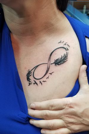 Infinity sign with feathers turning into birds 
