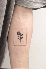 Minimalist tattoo. Rose surrounded by a thin rectangular border. 