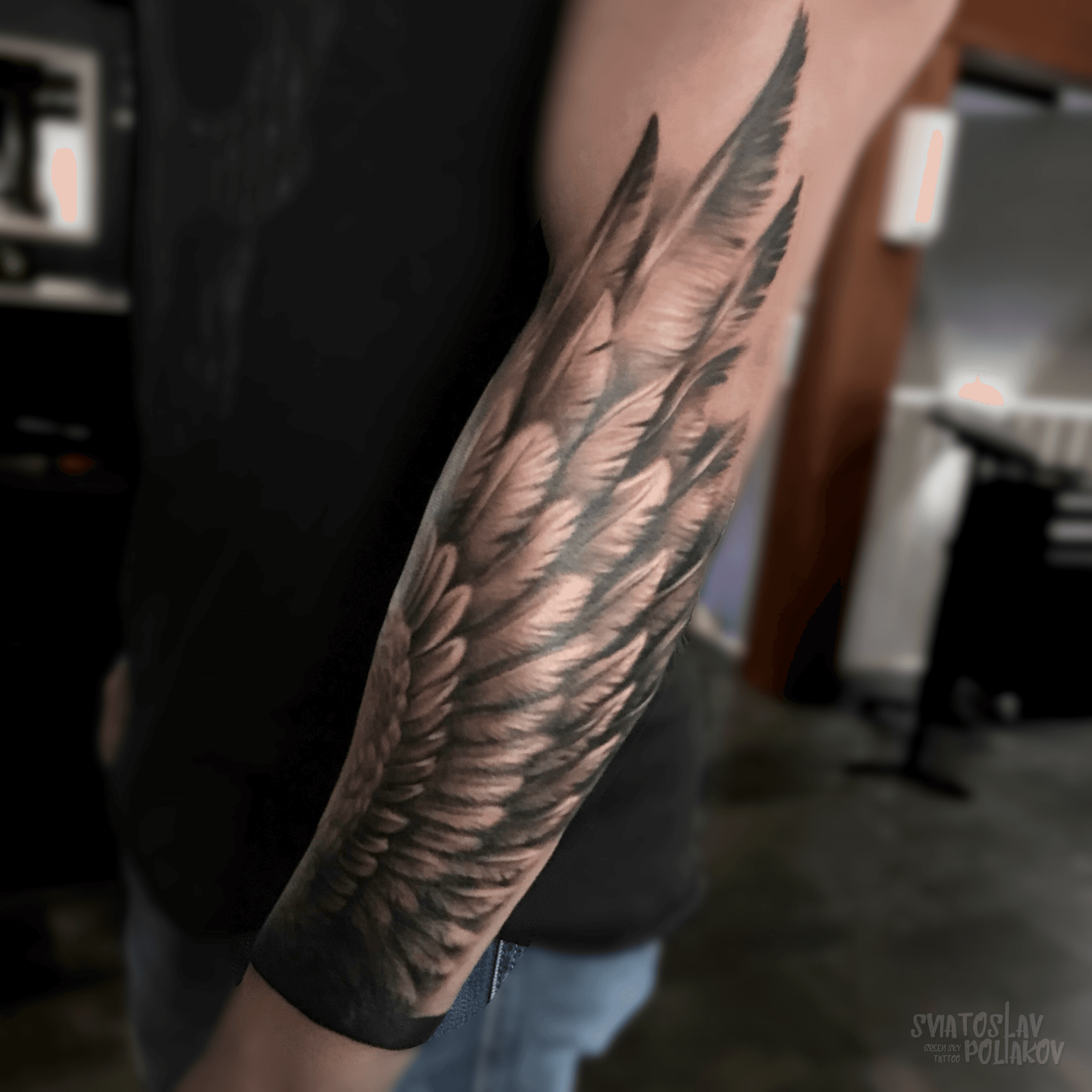 Wing tattoo on the left forearm