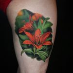 Flower tattoo by Liz Venom #LizVenom #TattoodoApp #TattoodoApptattooartist #tattooartist #tattooart #tattooidea #inspiringtattoo #besttattoo #awesometattoo #tigerlily #flower #leg #realism #realistic