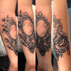 Mirror, flowers and crystals on forearm