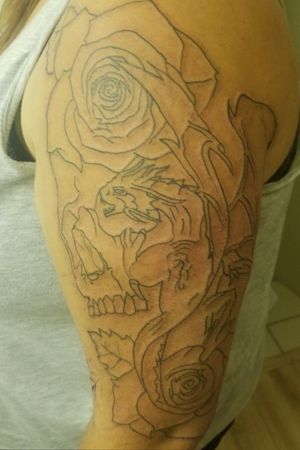 Outlines done on this half sleeve! Dragon, skull w/roses!