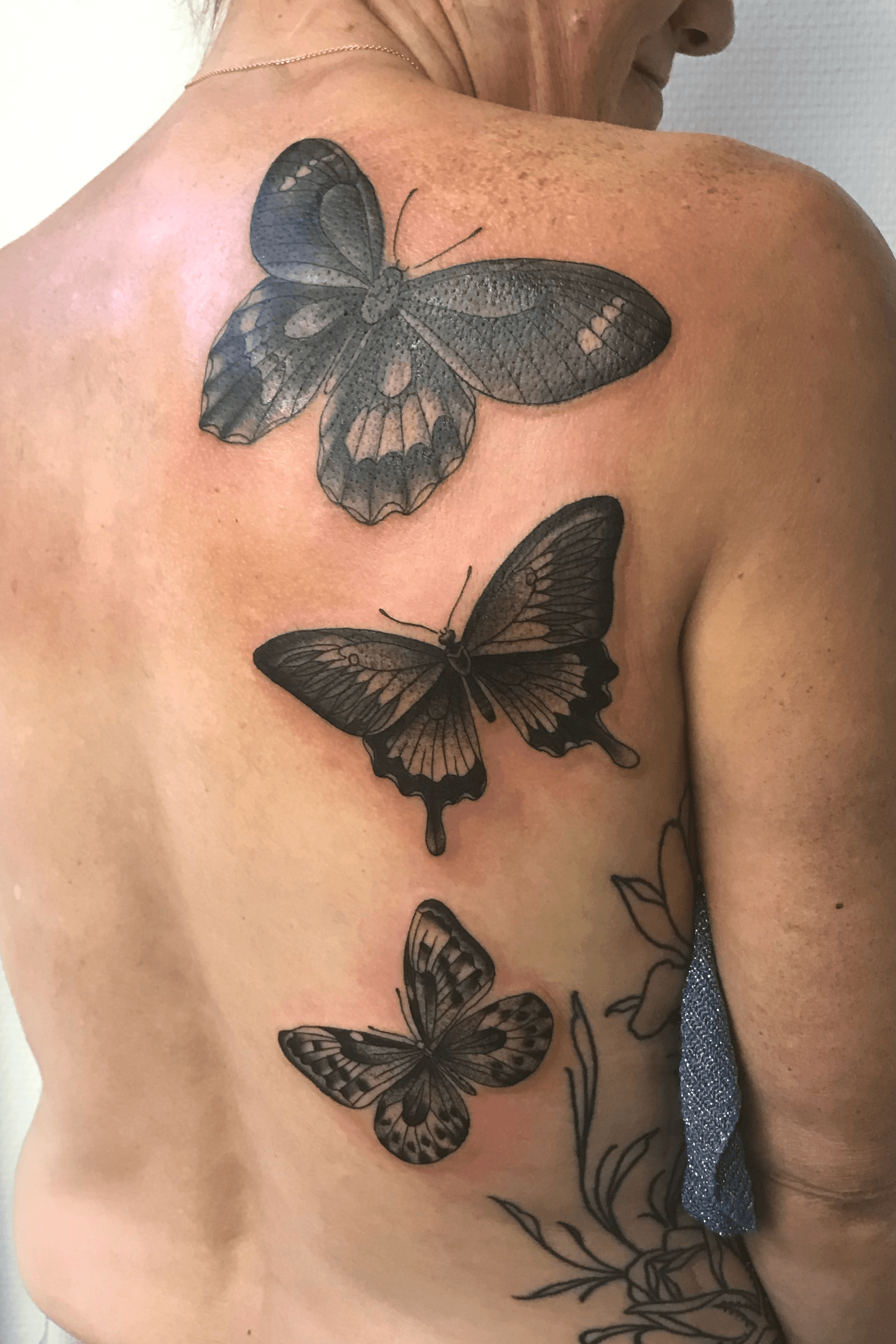 Fine line butterfly tattoo on the inner arm