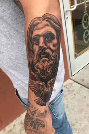 Christ statue and dove tattoo 