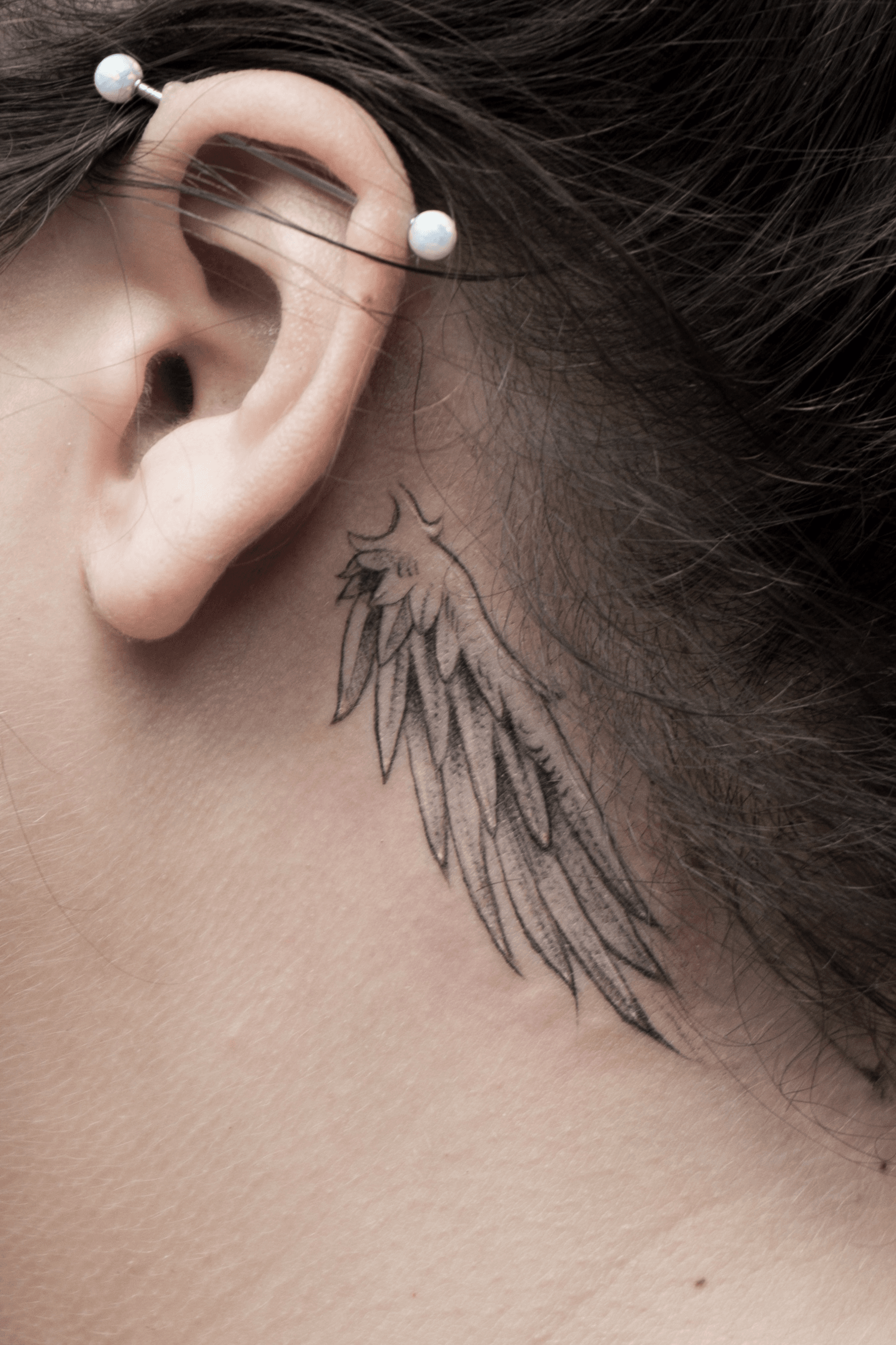 His angel carries me tattoo behind the right ear