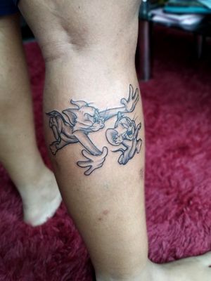 Tom and jerry themed tattoo resembling two best friends.