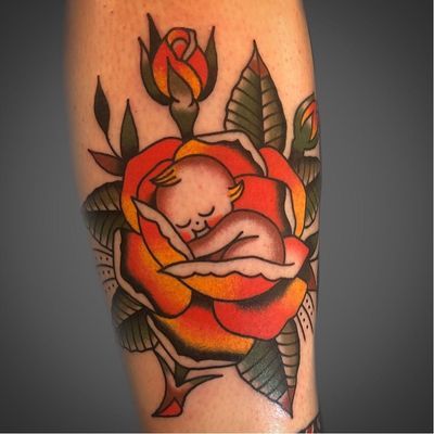 Traditional rose tattoo by Jeff P Gleason #JeffPGleason #TattoodoApp #TattoodoApptattooartist #tattooartist #tattooart #tattooidea #inspiringtattoo #besttattoo #awesometattoo #traditional #rose #kewpie #baby #cute #color #leg