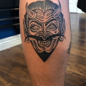 Black n grey traditional devil head tattoo