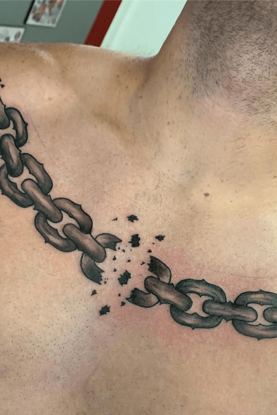 Broken chain tattoo