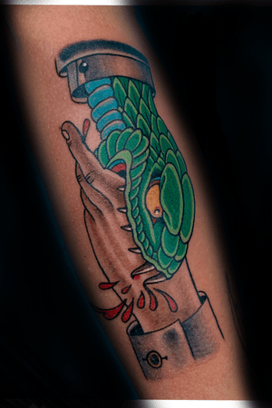 Illustrative forearm tattoo by Darren Brass featuring a snake, hand, and blood motif.