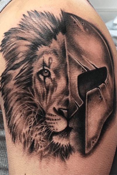Black and grey realism lion and spartan helmet tattoo 