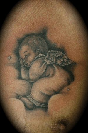 Sleeping angel,memorial tattoo on the chest 