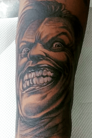 The joker face tattoo black and gray