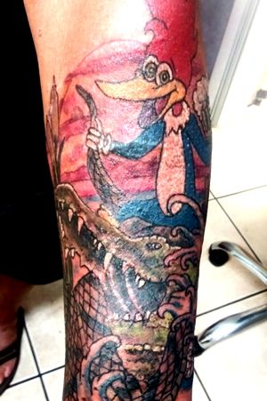 Customer wanted Woody tattoo cause his Nick name was Woody. I said use your imagination. So we came up with Woody riding an alligator with a water moccasin rope and a beer mug in his hand