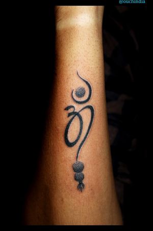 Om rudraksha tattoo at OUCH.                                      For bookings call at 7382521886, 9848597806