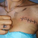 Heartbeat on chest & bow on finger tattoos 