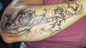 Rose pattern with stars on forearm. 