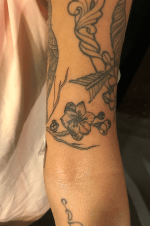 Cherry blossom on upper arm. Black and gray with shading. 3RL