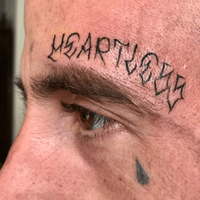 crown above eyebrow tattoo